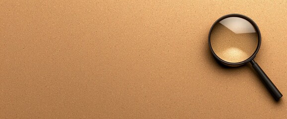 Magnifying glass on brown background.