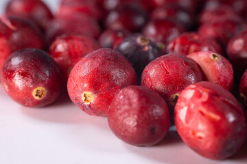 Close-up of freeze-dried cranberries, some whole and others halved, showcasing their vibrant red color and airy texture. Perfect for snacks, baking, or as a healthy topping.