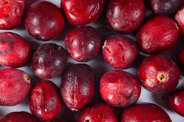Close-up of freeze-dried cranberries, some whole and others halved, showcasing their vibrant red color and airy texture. Perfect for snacks, baking, or as a healthy topping.