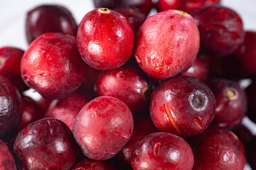 Close-up of freeze-dried cranberries, some whole and others halved, showcasing their vibrant red color and airy texture. Perfect for snacks, baking, or as a healthy topping.