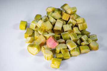 Close-up of freeze-dried rhubarb pieces showing vibrant green and pink hues, with a crisp texture....