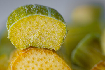 Close-up of freeze-dried rhubarb pieces showing vibrant green and pink hues, with a crisp texture. Perfect for snacking, baking, or adding a tangy flavor to dishes.