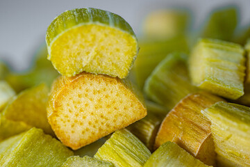 Close-up of freeze-dried rhubarb pieces showing vibrant green and pink hues, with a crisp texture. Perfect for snacking, baking, or adding a tangy flavor to dishes.