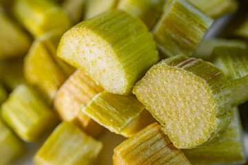 Close-up of freeze-dried rhubarb pieces showing vibrant green and pink hues, with a crisp texture. Perfect for snacking, baking, or adding a tangy flavor to dishes.