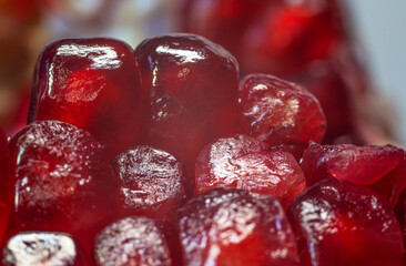 Close-up of several seeds of juicy ripe red pomegranate, macrophotography.