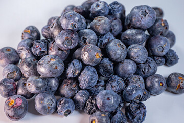 A detailed macro shot of freeze-dried blueberries, showcasing their wrinkled texture and rich blue-purple tones. Ideal for healthy food themes.