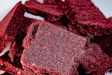 A detailed macro shot of freeze-dried banana and blueberry chips with a textured, crunchy appearance. Rich in vibrant colors and perfect for healthy snacks or culinary use.