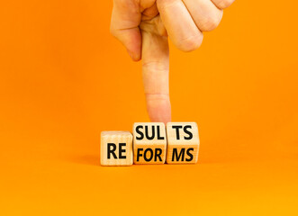 Reform and result symbol. Concept words Reforms Results on beautiful wooden block. Beautiful orange...