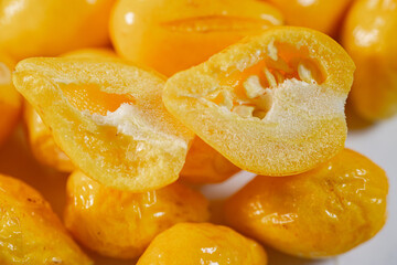 A detailed close-up of freeze-dried Argentine chili peppers, showcasing their vibrant yellow color, glossy texture, and seeds. Perfect for culinary or spice applications.