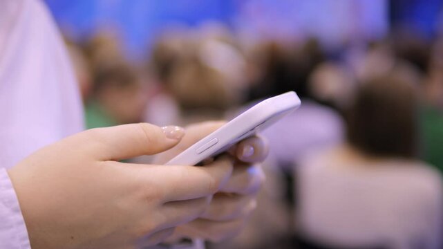 A person actively utilizing a smartphone during a conference vividly underscores the significance of mobile engagement