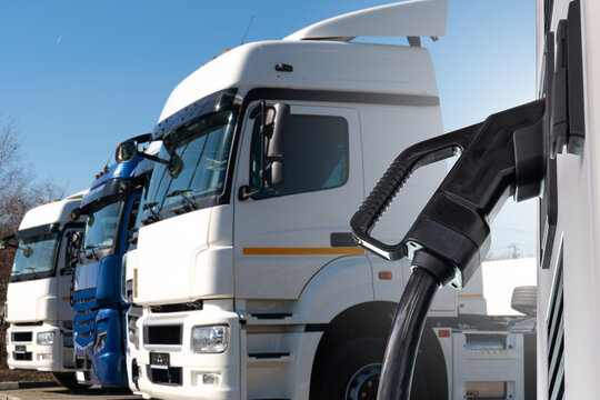 Electric vehicles charging station on a background of a trucks