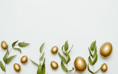 Close-up top view of golden Easter eggs on white background, Happy Easter minimal concept
