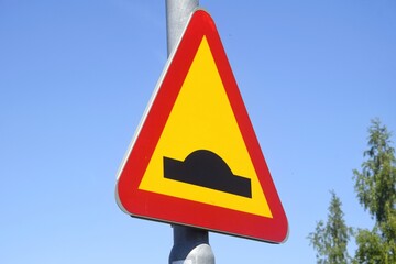 Warning sign, uneven road. Speed ​​limit on the street.