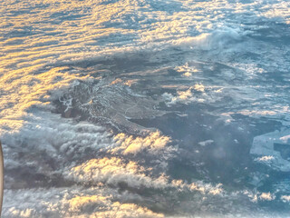 Aerial view of Puy de Sancy surrounded by clouds from passenger plane, Massif Central, France