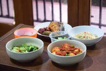 Asian vegetables fish chili eggs, and dishes food cuisine in a bowl on a brown table