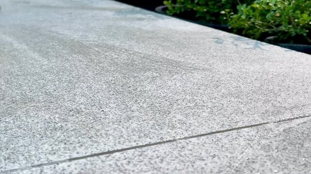 Cleaning marble floor with gloved hands and green cloth Close-up of gloved hands cleaning a light grey marble floor with a green microfiber cloth. This scene emphasizes cleanliness, hygiene and attent