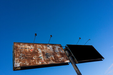 Old billboards against the blue sky.