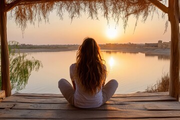 Young woman practicing yoga at sunset in siwa oasis, egypt