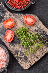 Sprigs of green fresh microgreen peas on wooden cutting board