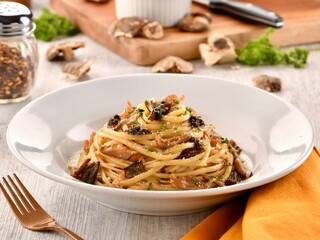 LINGUINE AL PROSCIUTTO E TARTUFO served in dish isolated on wooden table side view of italian fast...