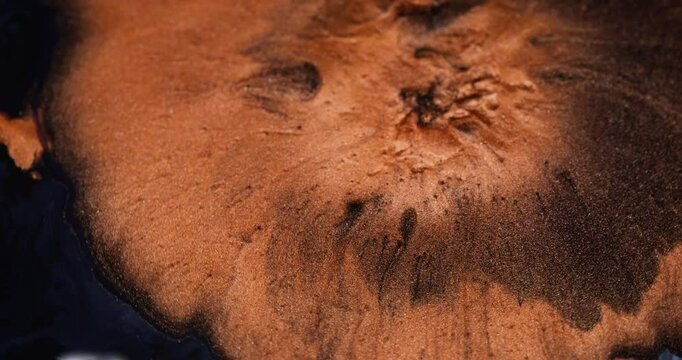 Ink spill. Shimmering explosion. Orange lava eruption volcano. Molten copper mass spread mix across black liquid abstract background.