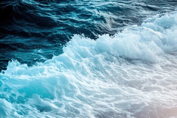 Fototapeta premium Ocean Waves Gradient: Waves crashing onto the shore with colors transitioning from deep navy blue to turquoise and white foam