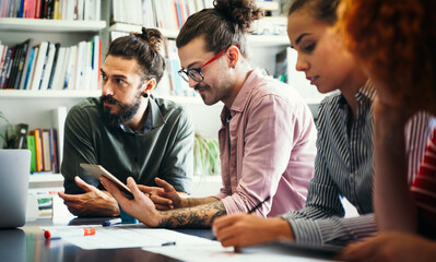 Diverse employees gathered in the office having fun during brainstorming while discussing new ideas