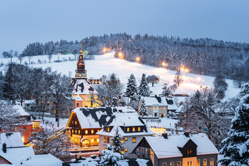 Illuminated houses and church in Seiffen at Christmastime. Saxony, Germany