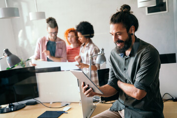 Group of business people and software developers working as a team in modern startup office