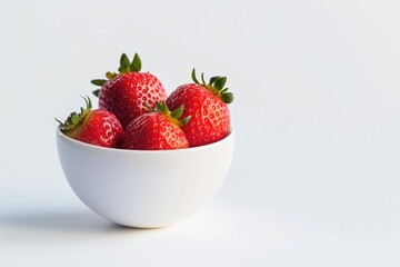 A white bowl filled with ripe strawberries