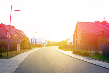 Street road on sunset at Suburban Scandi home. Contemporary barnhouse. Barn house on sunset. Barn...