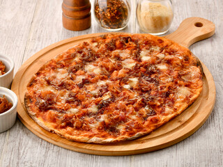 Crispy Bacon and Caramelized Onion Pizza served on wooden board side view of Italian fast food