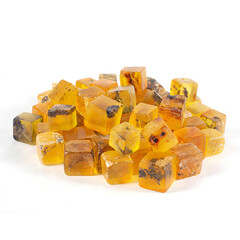A pile of yellow amber cubes workpiece with a white background