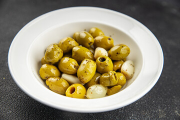 Olives mediterranean with garlic snack aperitif fresh tasty food dish  gourmet food background on the table rustic food top view copy space keto and paleo diet Vegetarian and vegan food