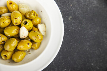 Olives mediterranean with garlic snack aperitif fresh tasty food dish  gourmet food background on...