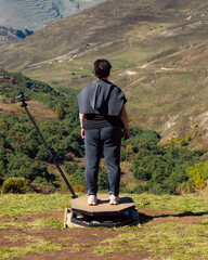 woman in center of 360-degree video spinner with a mounted action camera, close-up