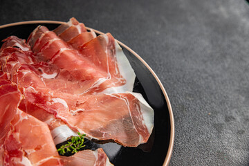 Jamon meat iberico or serrano snack aperitif fresh tasty food dish gourmet food background on the...