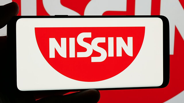 Stuttgart, Germany - 01-14-2025: Smartphone with logo of Japanese company Nissin Foods Holdings Co. Ltd. on screen. Focus on phone display.