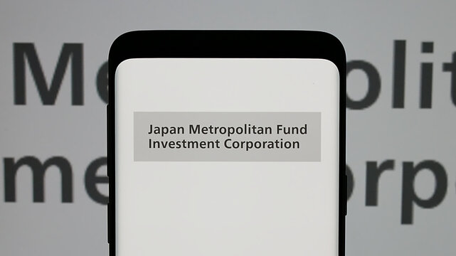 Stuttgart, Germany - 01-14-2025: Mobile phone with logo of Japan Metropolitan Fund Investment Corporation (JMF) on screen. Focus on phone display.