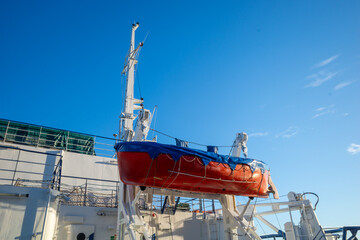 rescue boat fixed on board a sea vessel against the blue sky. copy space