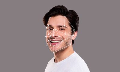A man displays a joyful expression while facial recognition technology analyzes his features. The...