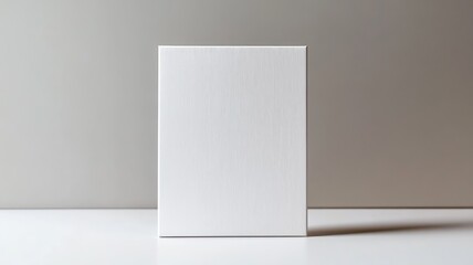 Plain white rectangular box standing upright on surface with minimalist background