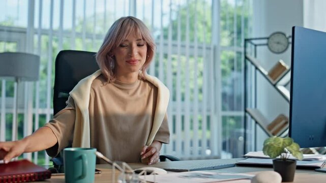Satisfied manager closing notebook at open space closeup. Woman sipping coffee