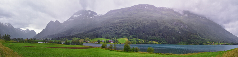 View to Sognefjord Olden in Norway 2024. Small town cruise port Olden Norwegian fjords, Rorbu houses. By Briksdal Glacier. Scandinavia, Europe.