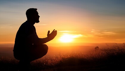 A silhouetted figure kneels in prayer against a vibrant sunset, evoking feelings of peace, reflection, and spirituality.