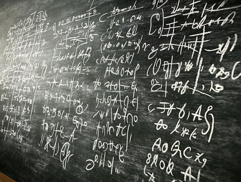 Intricate chalkboard filled with handwritten math equations and scientific formulas. Ideal for education, science, or technology concepts evokes a sense of learning and intellectual pursuit.