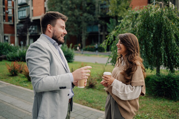 Two business colleagues enjoying coffee break and having a conversation