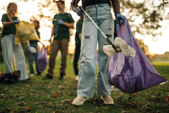 Group of volunteers collecting garbage in park