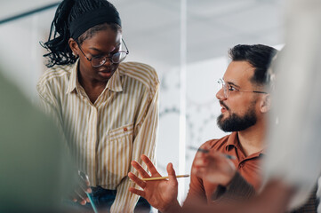 Business people collaborating on project in modern office environment