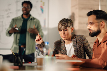 Businesswoman leading meeting, explaining strategy to colleagues in office